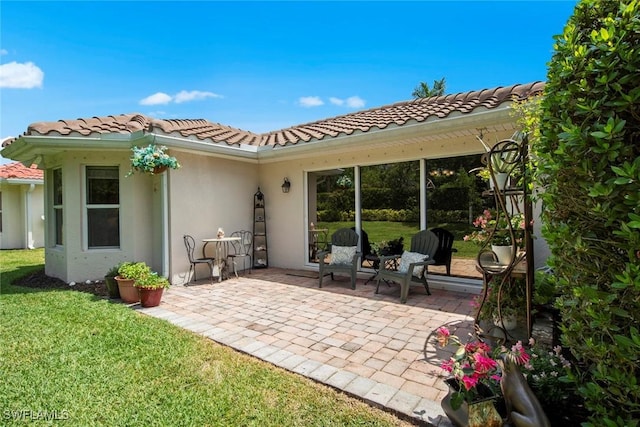 9046 Astonia Way, Estero, FL 33967 - rear view of house with a yard, a tile roof, a patio, and stucco siding
