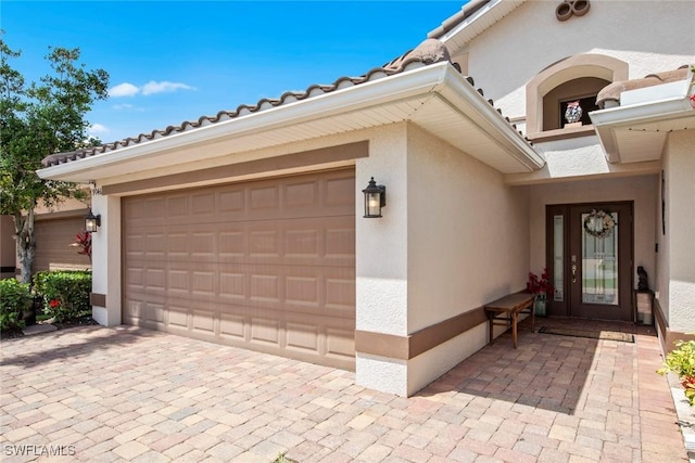 9046 Astonia Way, Estero, FL 33967 - exterior space featuring stucco siding, driveway, a tiled roof, and a garage