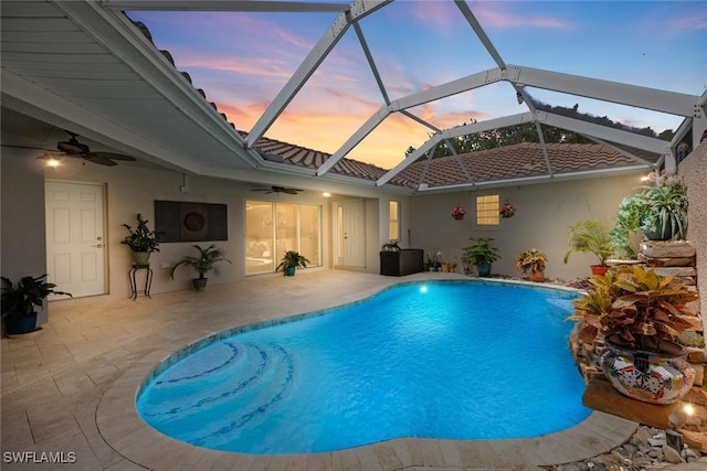 9046 Astonia Way, Estero, FL 33967 - pool at dusk with a patio area, a ceiling fan, an outdoor pool, and glass enclosure