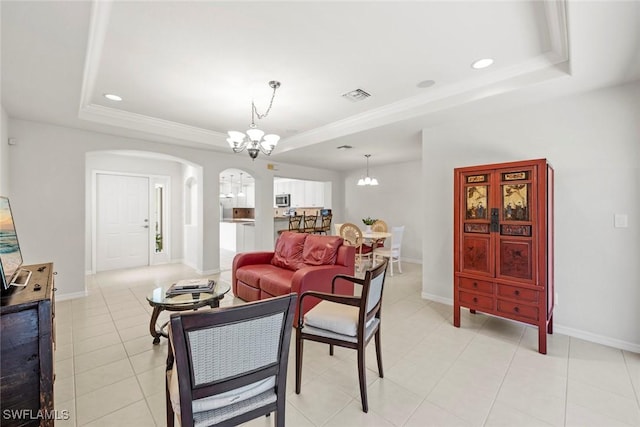 9046 Astonia Way, Estero, FL 33967 - living room with arched walkways, a notable chandelier, visible vents, and a raised ceiling