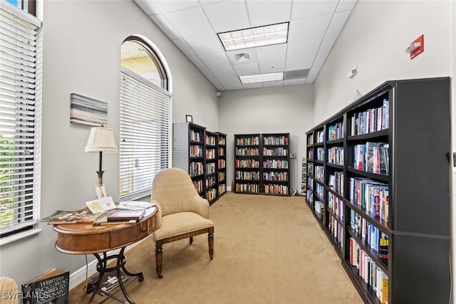 9046 Astonia Way, Estero, FL 33967 - living area with bookshelves, visible vents, carpet floors, and a drop ceiling