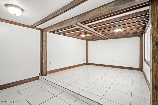 finished basement with marble finish floor and baseboards