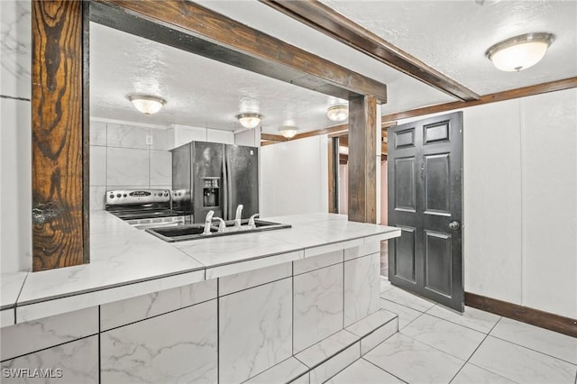 bathroom featuring baseboards, a sink, a textured ceiling, and marble finish floor