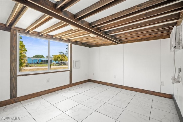 basement with baseboards and marble finish floor