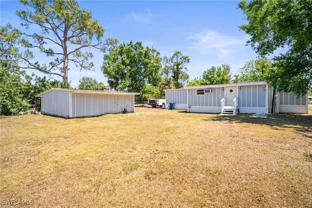 view of yard featuring entry steps and an outbuilding