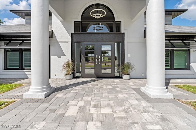 property entrance with french doors and stucco siding