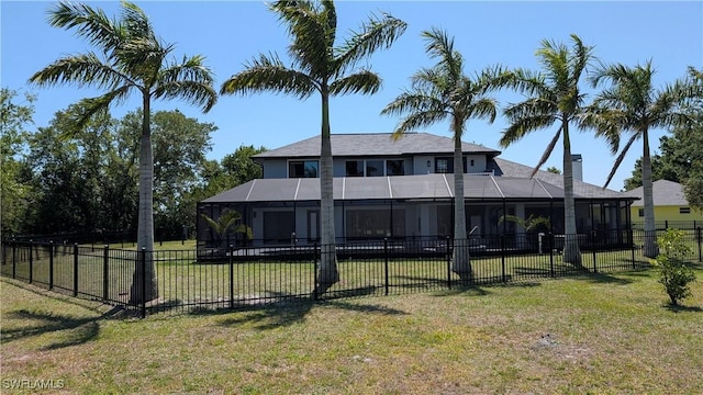 back of property featuring a fenced backyard, a yard, and glass enclosure