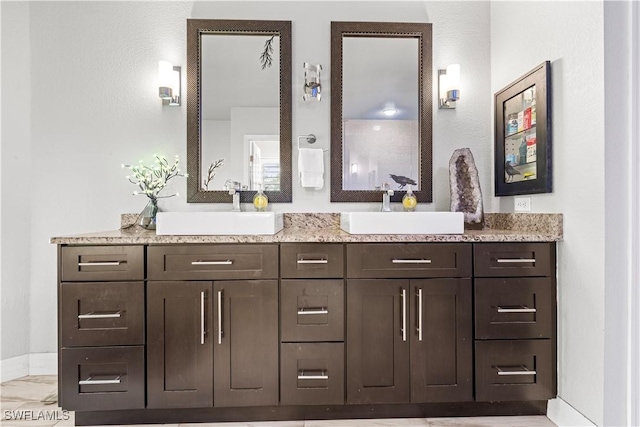 full bathroom featuring a sink and double vanity