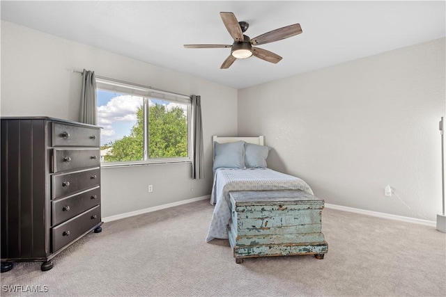 sitting room with carpet flooring, baseboards, and ceiling fan
