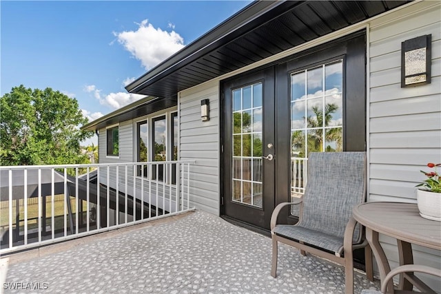 view of patio / terrace with a balcony and french doors