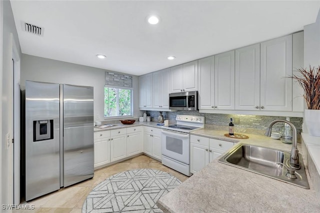 11499 Forest Mere Dr, Bonita Springs, FL 34135 - kitchen with light countertops, tasteful backsplash, stainless steel appliances, and a sink