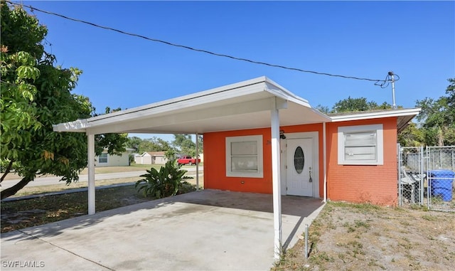 2605 Jackson St, Fort Myers, FL 33901 - bungalow with brick siding, driveway, fence, and an attached carport