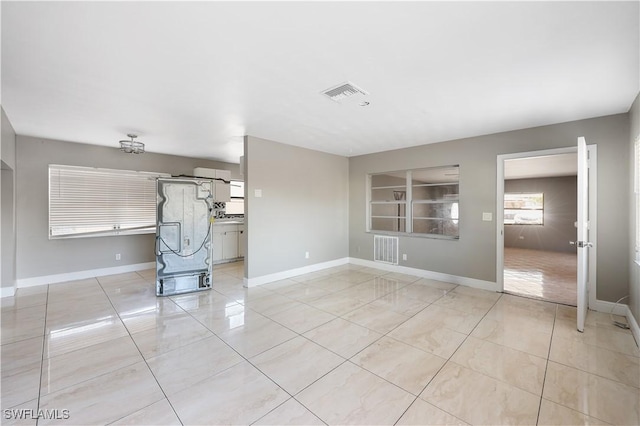 2605 Jackson St, Fort Myers, FL 33901 - unfurnished living room with visible vents, baseboards, and light tile patterned floors