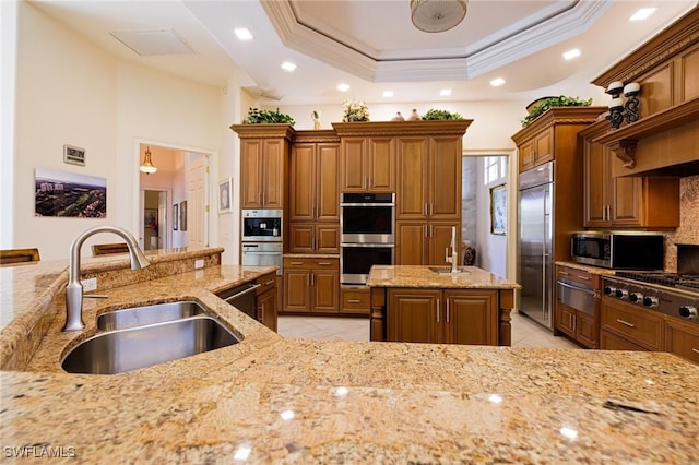 kitchen with appliances with stainless steel finishes, a sink, a warming drawer, light tile patterned floors, and recessed lighting