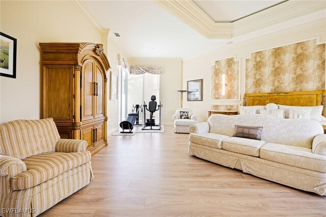 living room with light wood-style flooring, ornamental molding, and baseboards