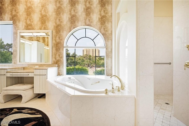 full bath featuring vanity, a tub with jets, tile patterned floors, and a walk in shower