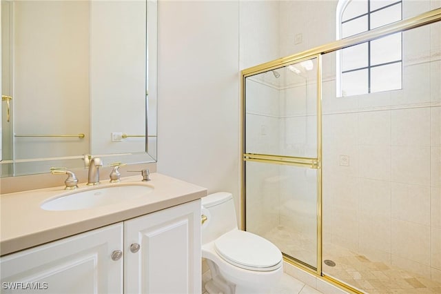 bathroom with toilet, a stall shower, and vanity