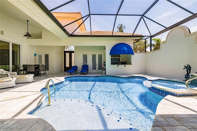 view of swimming pool featuring french doors, a patio area, a pool with connected hot tub, and ceiling fan
