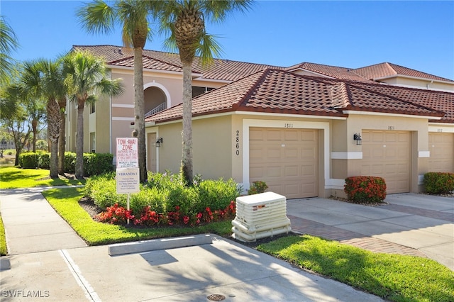 mediterranean / spanish-style house featuring stucco siding and a tiled roof