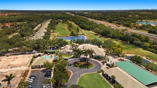 birds eye view of property with a water view and golf course view