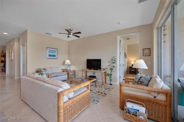 living room featuring light tile patterned floors, a ceiling fan, baseboards, and recessed lighting
