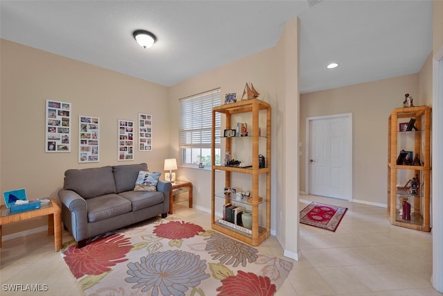 living area featuring baseboards, light tile patterned flooring, and recessed lighting