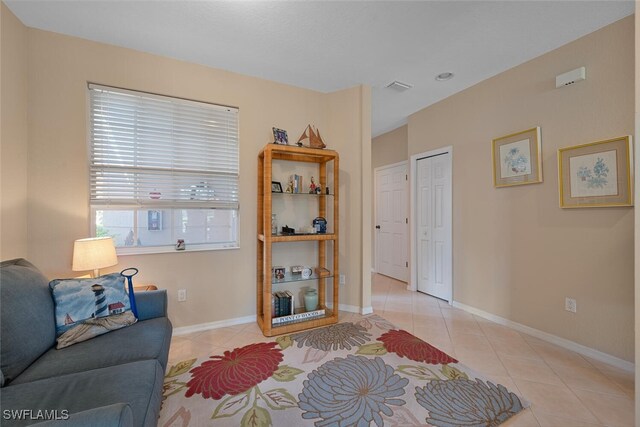 living room with light tile patterned floors and baseboards