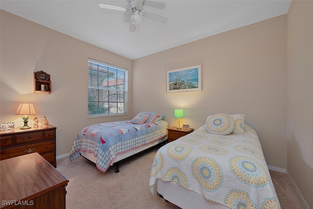 bedroom with carpet flooring, baseboards, and a ceiling fan