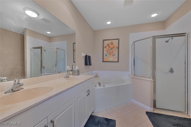 full bath with a stall shower, tile patterned flooring, a bath, and double vanity