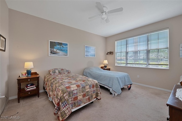 bedroom featuring carpet floors, baseboards, and a ceiling fan