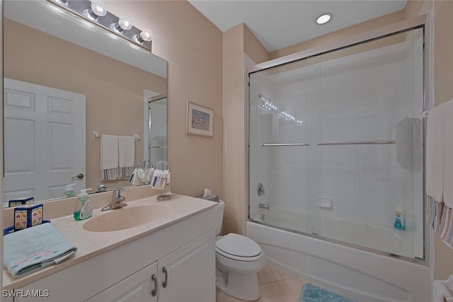 bathroom featuring tile patterned flooring, toilet, vanity, and shower / bath combination with glass door