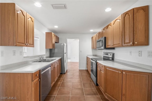 kitchen with visible vents, appliances with stainless steel finishes, a sink, light countertops, and recessed lighting