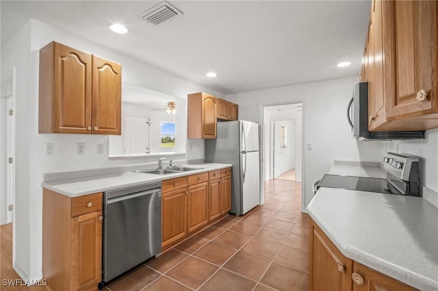 kitchen featuring light countertops, stainless steel appliances, visible vents, and a sink