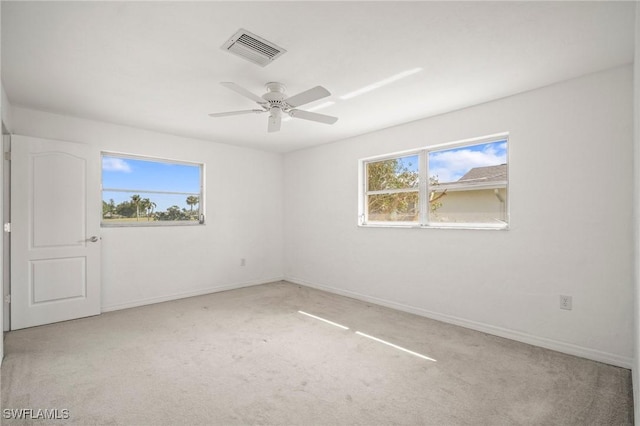 unfurnished room featuring carpet flooring, baseboards, and visible vents