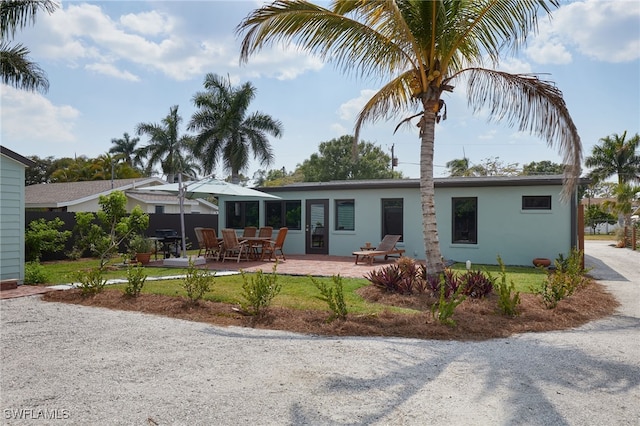 27551 Pullen Ave, Bonita Springs, FL 34135 - rear view of property with stucco siding and a patio