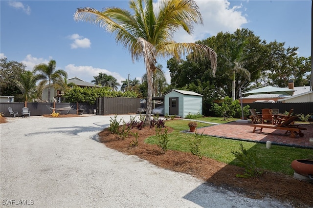 27551 Pullen Ave, Bonita Springs, FL 34135 - view of yard with an outdoor structure, fence, a patio area, and a shed
