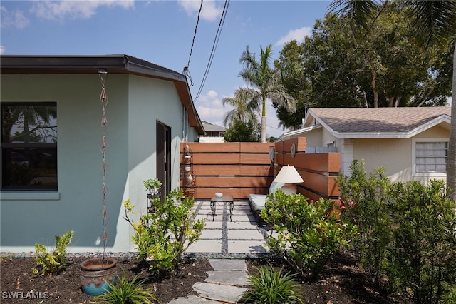27551 Pullen Ave, Bonita Springs, FL 34135 - view of side of home featuring fence and stucco siding