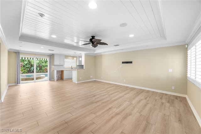 1135 7th St S, Naples, FL 34102 - unfurnished living room featuring a raised ceiling, crown molding, healthy amount of natural light, light wood finished floors, and ceiling fan