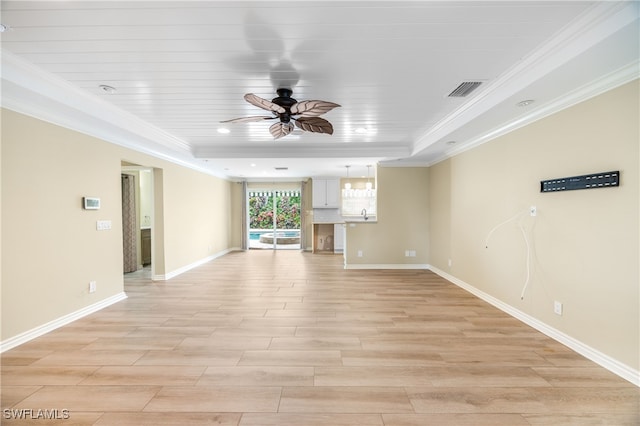 1135 7th St S, Naples, FL 34102 - unfurnished living room with ceiling fan, light wood-style floors, crown molding, and a raised ceiling
