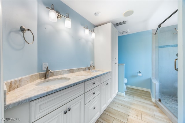 1135 7th St S, Naples, FL 34102 - full bath with a stall shower, double vanity, and wood finish floors