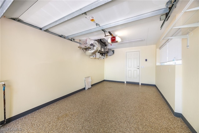 1135 7th St S, Naples, FL 34102 - garage featuring baseboards and a garage door opener