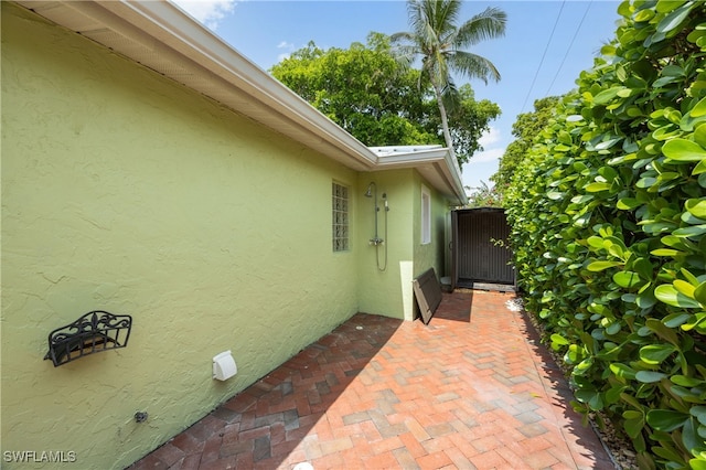 1135 7th St S, Naples, FL 34102 - view of home's exterior featuring stucco siding and a patio
