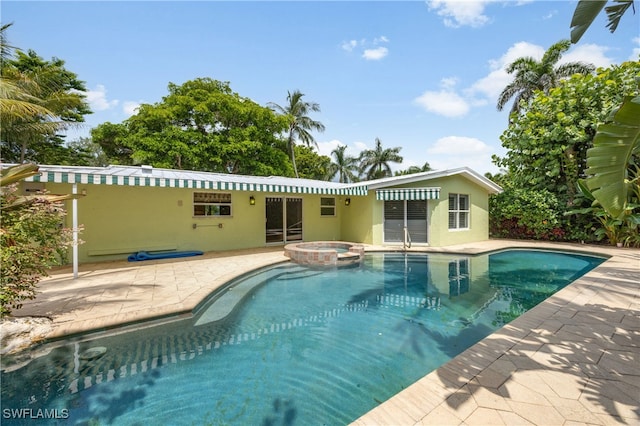 1135 7th St S, Naples, FL 34102 - view of swimming pool featuring a patio and a pool with connected hot tub