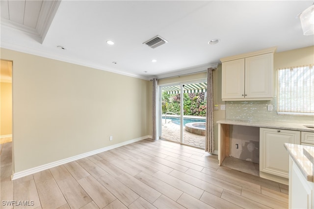 1135 7th St S, Naples, FL 34102 - kitchen featuring light wood finished floors, ornamental molding, backsplash, light stone counters, and recessed lighting