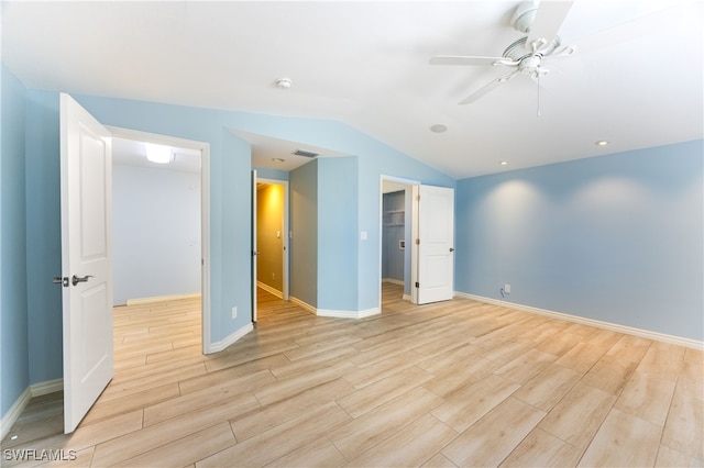 1135 7th St S, Naples, FL 34102 - unfurnished bedroom featuring light wood-type flooring, lofted ceiling, a walk in closet, and a ceiling fan