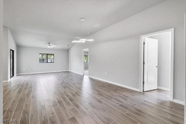 3225 58th St W, Lehigh Acres, FL 33971 - unfurnished room with wood finished floors, baseboards, and ceiling fan