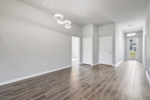 3225 58th St W, Lehigh Acres, FL 33971 - interior space with a chandelier, baseboards, visible vents, and dark wood finished floors