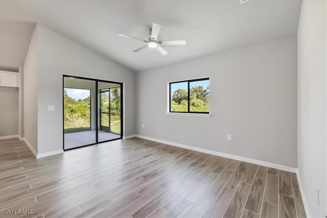 3225 58th St W, Lehigh Acres, FL 33971 - spare room with light wood-type flooring, vaulted ceiling, baseboards, and a healthy amount of sunlight