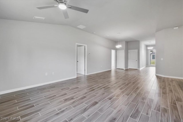 3225 58th St W, Lehigh Acres, FL 33971 - unfurnished living room with a ceiling fan, baseboards, lofted ceiling, and wood finished floors