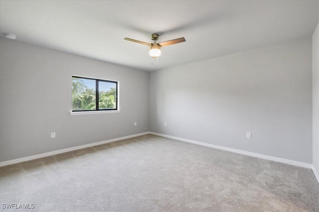 3225 58th St W, Lehigh Acres, FL 33971 - carpeted spare room with baseboards and a ceiling fan